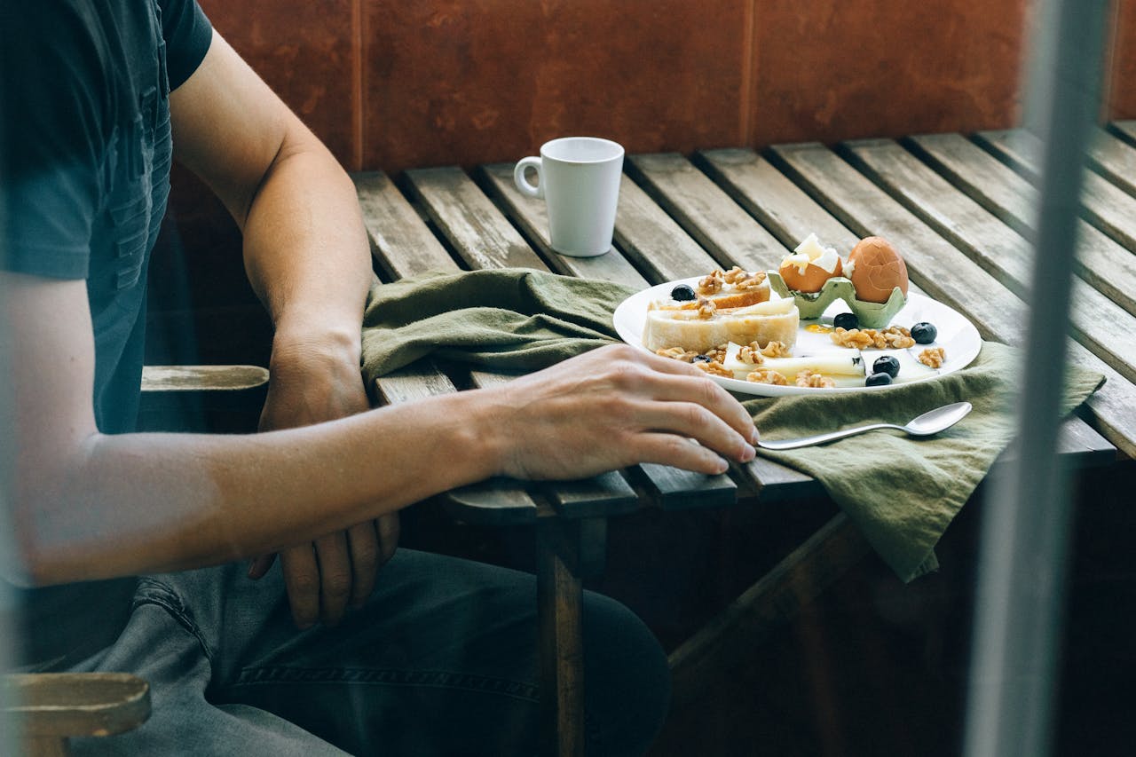 person enjoying their meal at in house restaurant, with eco kerala stays